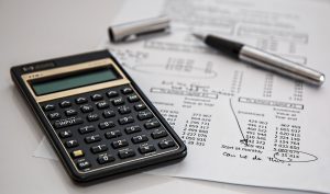 calculator, pen, and files for bankruptcy cases